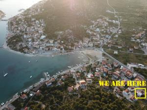 an aerial view of a town on a hill next to the water at Apartments Bilanovic in Tisno