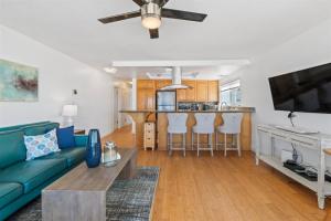 a living room with a blue couch and a kitchen at 104-unit 4 in San Diego