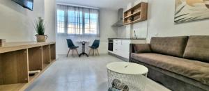a living room with a couch and a table at Cardón Jandía 2A in Morro del Jable