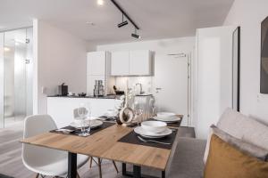 a dining room with a wooden table and chairs at Max Studios & Apartments - Zillertal in Schlitters