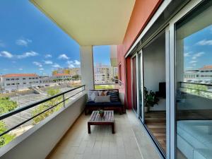 a balcony with a couch and a table at My Place in Portimão