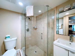 a bathroom with a shower and a toilet and a sink at Copley House Extended Stay in Boston