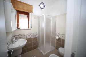 a bathroom with a shower and a toilet and a sink at B&B VANNEFORA in San Nicola Arcella
