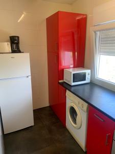 a kitchen with a white refrigerator and a microwave at Apartamento parque las llamas in Santander