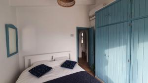 a bedroom with a white bed with blue pillows at Binibeca Vell Luxury Villa, sea direct access, private pool in Binibeca +27 photos