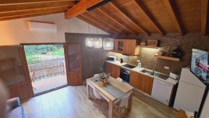 a kitchen with a table and a counter top at Casa do Moleiro in Lousã