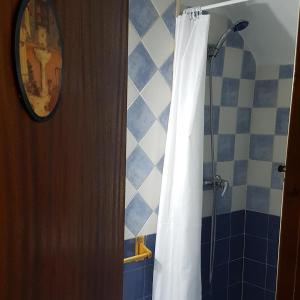 a bathroom with a shower with a white shower curtain at Manxalo in Sant Mateu