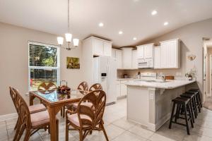 a kitchen and dining room with a table and chairs at Moody Oaks in Orange Park