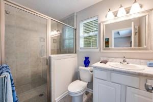 a bathroom with a toilet and a sink and a shower at Moody Oaks in Orange Park +36 photos