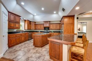 a large kitchen with wooden cabinets and a large island at The Tree House in Middleburg