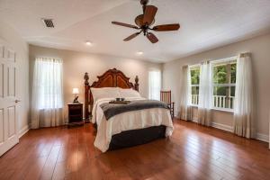 a bedroom with a bed and a ceiling fan at The Tree House in Middleburg