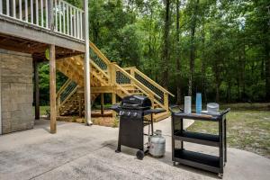 a grill on a patio with a wooden stairs at The Tree House in Middleburg +42 photos
