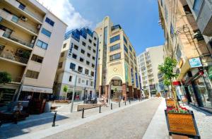 an empty street in a city with tall buildings at Sliema Creek Suites in Sliema