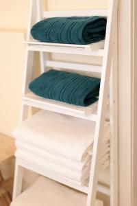 a white towel rack with green towels on it at Villa Sunny Ičići- Apartment Sun in Ičići