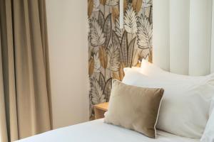 a bedroom with a bed with a pillow and a curtain at One Design Hotel in Rimini