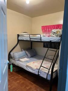 a room with two bunk beds in a room at Serenity House in Baguio