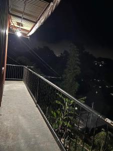 a balcony of a house at night with a view at Serenity House in Baguio