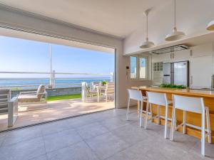 a kitchen and dining room with a view of the ocean at Villa Isabel in Playa del Ingles