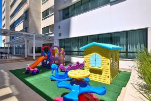 a childrens playground with a play set on a patio at True América apart-hotel in Campos dos Goytacazes