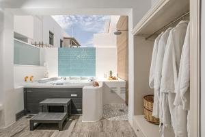 a bathroom with a large sink and a tub at Blue Sky Summer in Naxos Chora