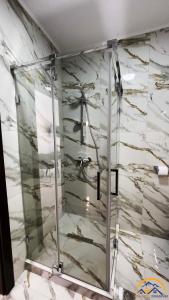 a glass shower in a bathroom with a marble wall at Conacul Doamnei in Corbi +120 photos