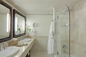 a bathroom with two sinks and a shower at Colony Club, a Luxury Collection Resort, Barbados in Saint James +84 photos