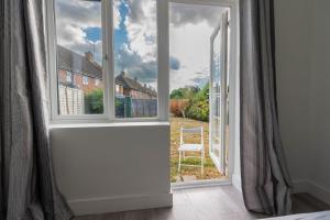 an open door with a view of a yard at Flat 04 Studio flat close to Aylesbury town and Station Free Parking in Buckinghamshire