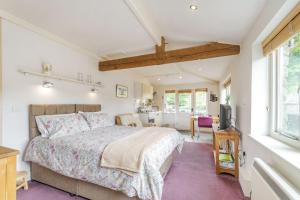 a bedroom with a bed and a living room at The Friendly Room in Austwick