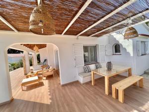 a living room with a table and a dining room at Villa Ona in Son Bou