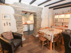 a kitchen and dining room with a table and chairs at Bwthyn Y Felin Star in Clydey