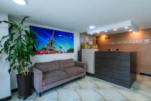 a living room with a couch in a lobby at Hotel Med Estadio in Medellín