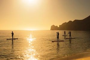 a group of people on paddle boards in the water at Breathless Cabo San Lucas - Adults Only in Cabo San Lucas