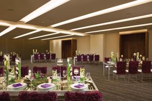 a banquet room with tables and chairs and purple chairs at Breathless Cabo San Lucas - Adults Only in Cabo San Lucas