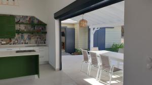 a kitchen with a table and chairs and a dining room at Majesty Palm in Saint-François