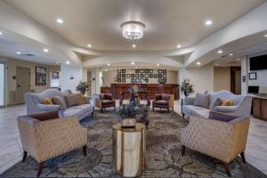 a lobby with couches and chairs and a fireplace at BEST WESTERN PLUS Monica Royale Inn & Suites in Greenville