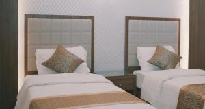 Al-Borg Al-Watheer Serviced apartments客房内的一张或多张床位