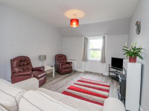 a living room with a couch and two chairs at The Knowe Upper in Taynuilt