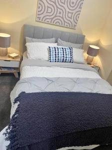 a bedroom with a large bed with blue and white pillows at Morgan Place - Central Melbourne CBD Apartment on Flinders Lane Late Check-Out, Complimentary Welcome Hamper in Melbourne +36 photos