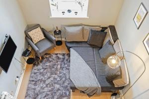 an overhead view of a living room with a couch and chairs at Duplex 3 Bedroom Mezzanine Apartment - Heart of Edinburgh in Edinburgh