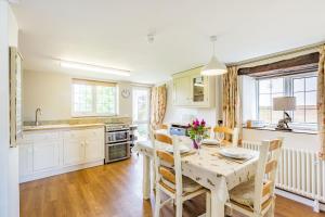 a kitchen and dining room with a table and chairs at Hillside Cottage in Bridgwater