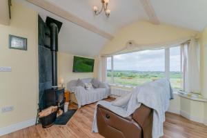 a living room with a couch and a fireplace at Crown Cottage in Holywell