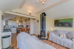 a living room with a couch and a stove at Crown Cottage in Holywell