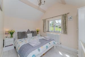 a bedroom with a bed and a window at Crown Cottage in Holywell