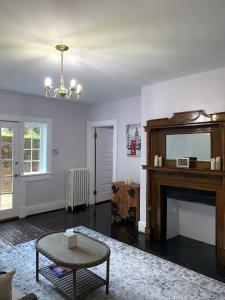 a living room with a fireplace and a mirror at Historical District 2BDRM built in 1910 in Lynchburg