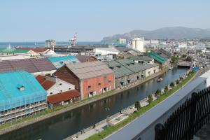 arial view of a city with a river and buildings at Hotel Nord Otaru in Otaru
