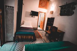 Postel nebo postele na pokoji v ubytování Riad Rasia