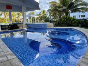 a swimming pool with blue tiles in a resort at Wave nSea Monterrico in Monterrico