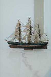 a wooden boat sitting on top of a table at Sea Air Inn & Suites - Downtown - Restaurant Row in Morro Bay +125 photos