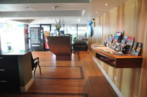 a large room with a large window and a large counter top at City Park Hotel in Melbourne