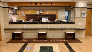 a store front with three benches in a shopping mall at Toyoko Inn Hakata-eki Minami in Fukuoka